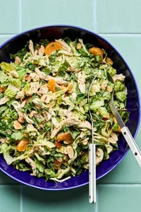Bright sesame chicken salad with juicy orange slices and sliced almonds with a homemade miso dressing