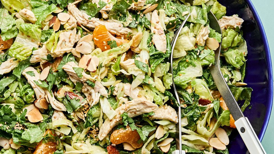 Bright sesame chicken salad with juicy orange slices and sliced almonds with a homemade miso dressing