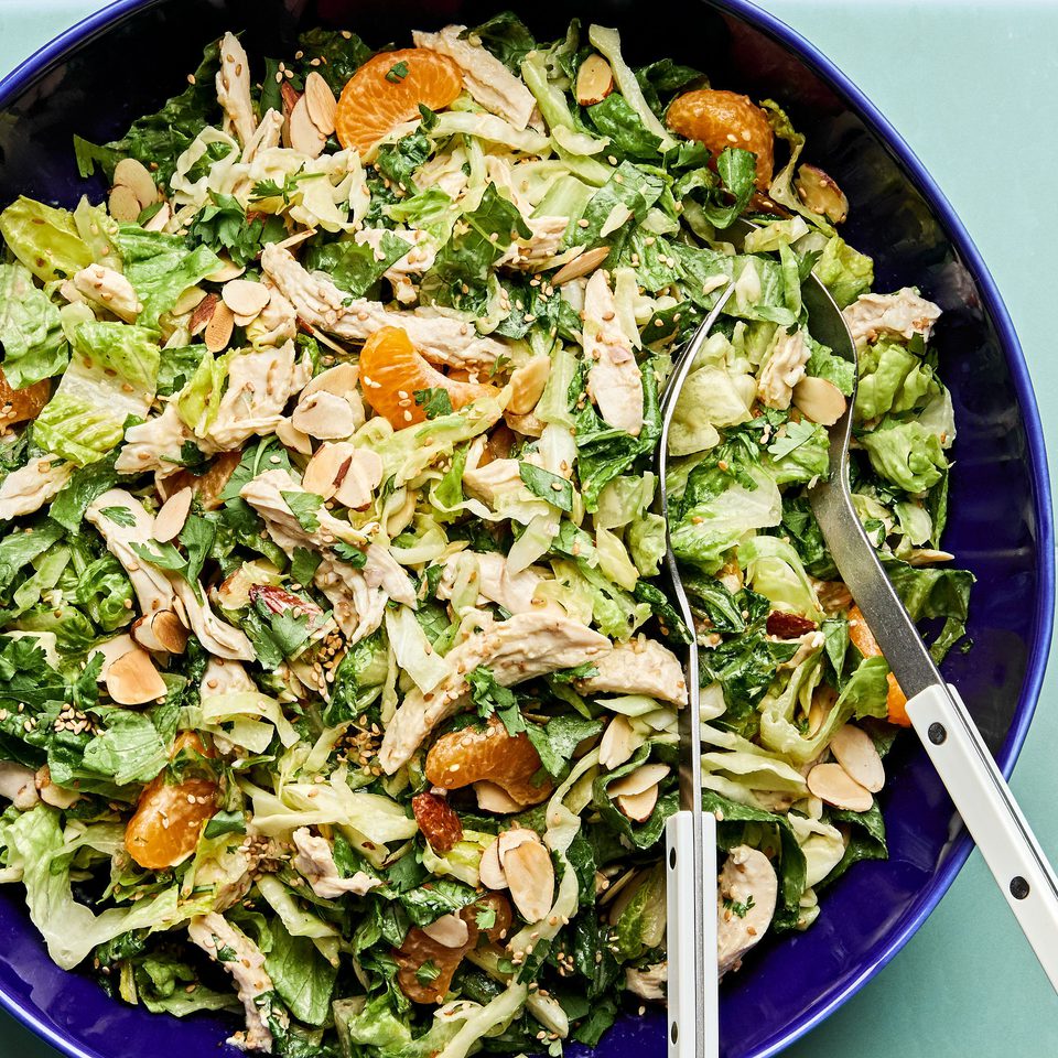 Bright sesame chicken salad with juicy orange slices and sliced almonds with a homemade miso dressing