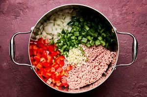 ground turkey, bell peppers, jalapeno and garlic cooking in a pot to make southwest turkey & quinoa soup