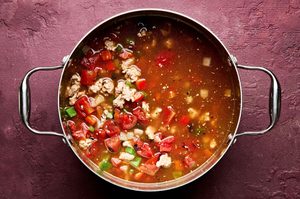 a pot of healthy and hearty southwest turkey & quinoa soup with black beans, bell peppers and fire roasted tomatoes