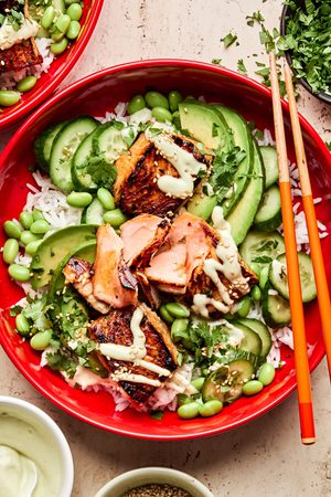 Teriyaki Salmon Bowl with coconut rice, edamame, cucumbers & avocado drizzled with wasabi dressing, the perfect summer meal