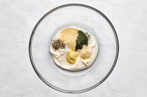 a creamy dressing being made in a bowl for the perfect make ahead tuna pasta salad recipe