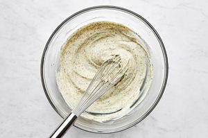 a creamy dressing being made in a bowl for the perfect make ahead tuna pasta salad recipe