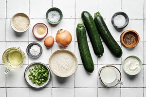 ingredients laid out and arranged on a counter to make zucchini fritters