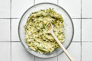 a bowl of zucchini fritter batter ready to be cooked in oil