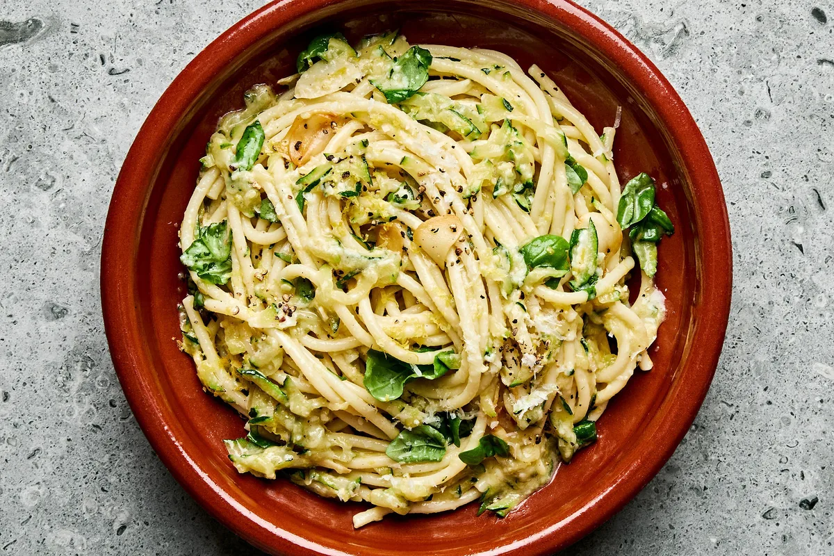 a bowl of zucchini pasta made with Spaghetti noodles coated in a creamy Parmesan zucchini sauce