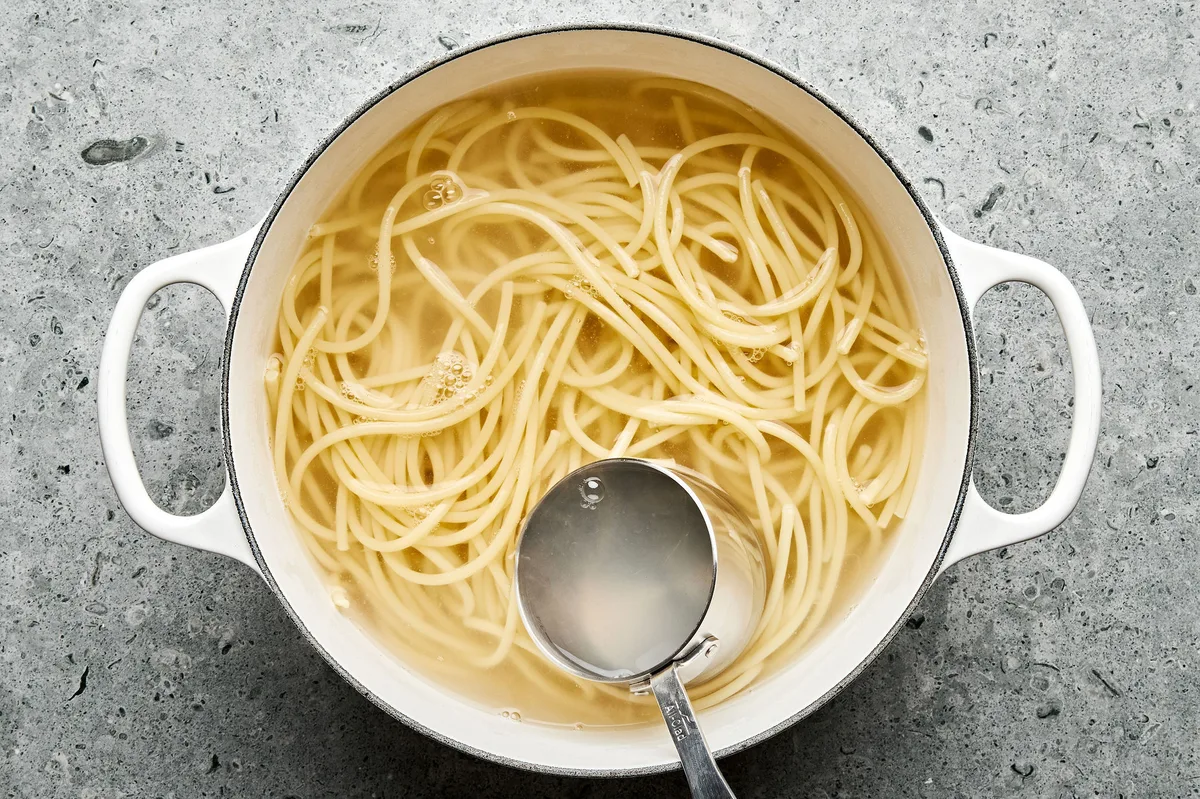 spaghetti noodles cooking a pot of salted boiling water