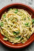 a bowl of zucchini pasta made with Spaghetti noodles coated in a creamy Parmesan zucchini sauce