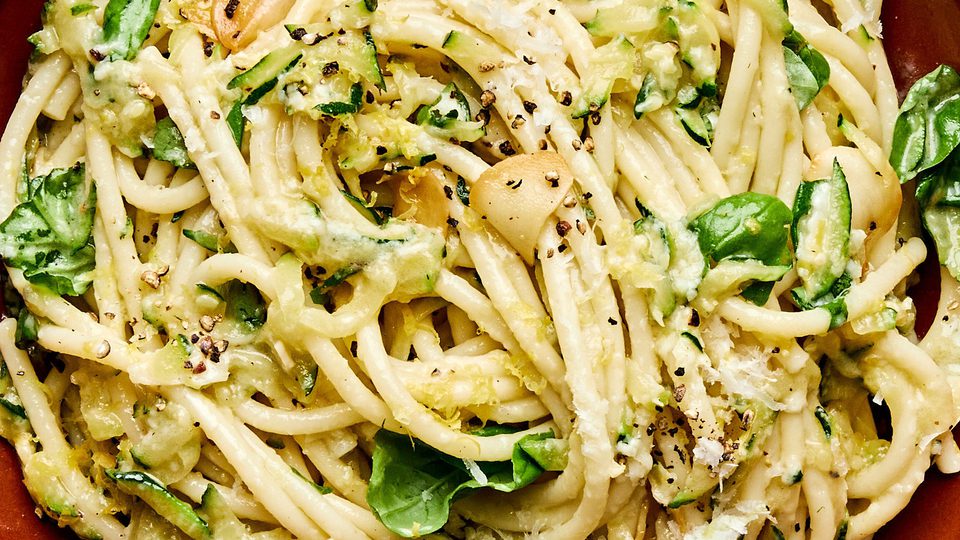 a bowl of zucchini pasta made with Spaghetti noodles coated in a creamy Parmesan zucchini sauce
