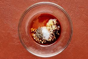 honey, garlic, ginger, soy sauce, vinegar, sesame oil, salt, and pepper combined in a small glass bowl