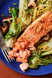 garlic ginger salmon on a plate with zucchini noodles, bok choy and shitake mushrooms