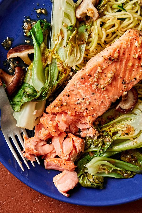 garlic ginger salmon on a plate with zucchini noodles, bok choy and shitake mushrooms