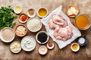 raw chicken thighs, rice, orzo, spices, currants, chicken stock and lemon zest in prep bowls
