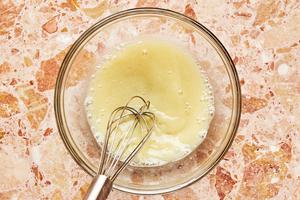 lemon juice, mustard, sugar, and salt being whisked in a bowl