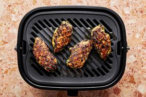 grilled pesto chicken on a grill