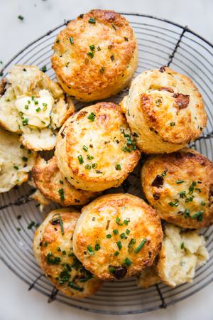 bacon cheddar and chive biscuits on a wire baking rack with chive butter