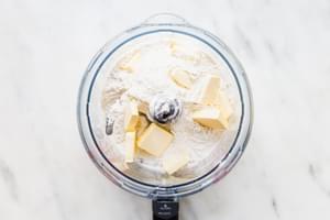butter, flour, baking soda, baking powder in the base of a food processor