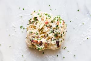 bacon cheddar cheese and chive buttermilk biscuit dough on a marble surface
