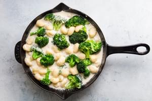 cream cheese, chicken stock, broccoli, gnocchi and mozzarella getting ready to bake