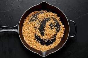 panko being toasted in butter in a skillet