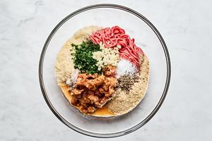 ground beef, ground Italian sausage, breadcrumbs, Parmesan, parsley, eggs, garlic, salt, and pepper being combined in a bowl