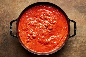 pasta sauce made with Italian sausage, ground beef, onion, cream, onion, garlic and spices in a large pot