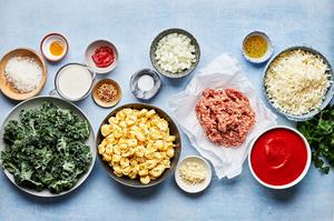 tortellini, kale, italian sausage, onion, tomato paste, creamy and spices in prep bowl to make baked tortellini