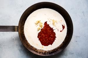 thai chili sauce, garlic and heavy cream in a pan for bang bang sauce
