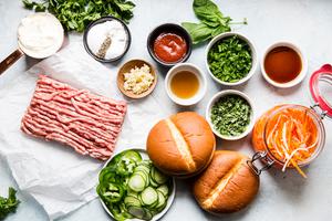 ingredients laid out for banh mi burgers pork, cucumbers, carrots, Sriracha