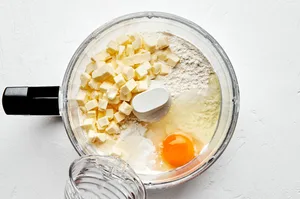 flour, salt, butter, eggs and ice water in a food processor to make homemade flaky empanada dough