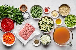 ground beef, zucchini, green beans, carrots, onion, celery, stock, crushed tomatoes, lentils and spices in prep bowls