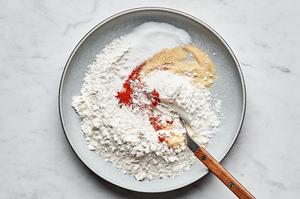 flour, cayenne, garlic powder and salt being whisked together in a bowl