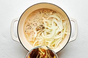beer, onion, onion powder, garlic powder, pepper, and salt being added to a large pot for beer brats