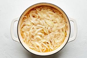 beer, onion, onion powder, garlic powder, pepper, and salt being in a large pot for beer brats