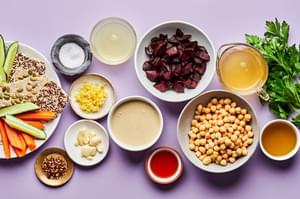 chickpeas, beets, tahini, olive oil, lemon zest & juice, red wine vinegar, spices, crackers & vegetables in prep bowls