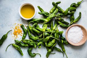 shishito peppers, sea salt, olive oil and lemon zest on a counter