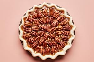 a homemade bourbon pecan pie ready to be baked in the oven