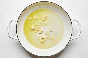 garlic cooking in olive oil in a pot
