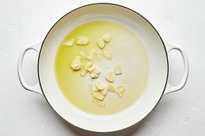 garlic cooking in olive oil in a pot