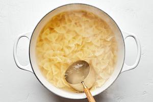 bow tie pasta noodles being cooked in salted water