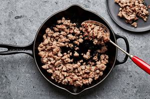 breakfast sausage being cooked in a skillet