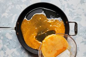 eggs whisked with salt and green chiles being cooked in a skillet