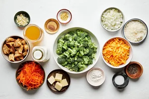 butter, onion, carrot, garlic, flour, spices, milk, stock, broccoli, Parm and cheddar in bowls to make broccoli cheddar soup