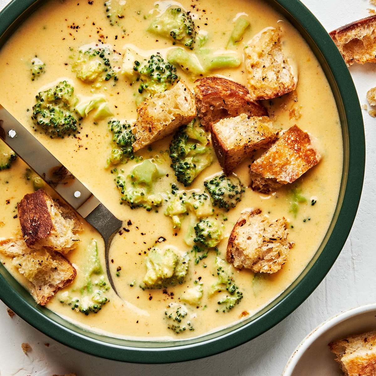Creamy broccoli cheddar soup in a bowl, topped with crunchy golden croutons, perfect for a cozy lunch or dinner