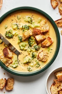 Creamy broccoli cheddar soup in a bowl, topped with crunchy golden croutons, perfect for a cozy lunch or dinner