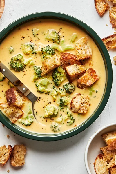 Creamy broccoli cheddar soup in a bowl, topped with crunchy golden croutons, perfect for a cozy lunch or dinner