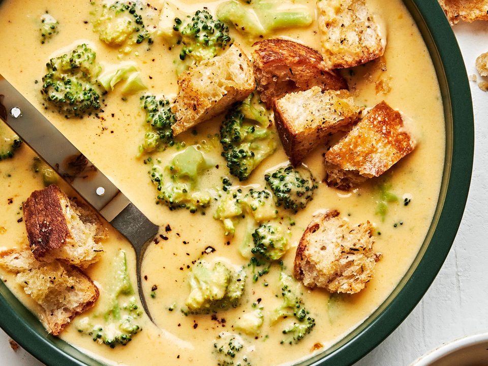 Creamy broccoli cheddar soup in a bowl, topped with crunchy golden croutons, perfect for a cozy lunch or dinner