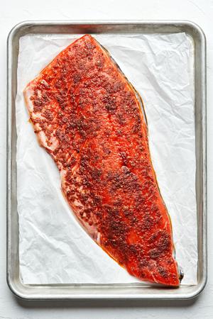 salmon filet seasoned with olive oil, brown sugar, salt, paprika, garlic powder, onion powder, pepper, and mustard