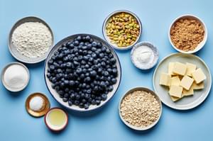 pistachios, butter, flour, oats, brown sugar, salt, blueberries, cornstarch, sugar and lemon juice in prep bowls